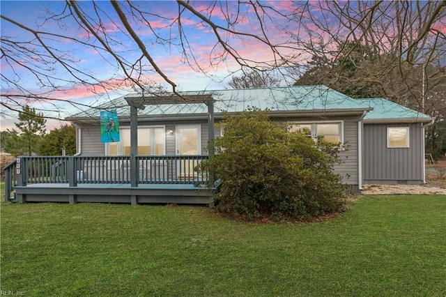 back of property featuring crawl space, a lawn, board and batten siding, and a deck