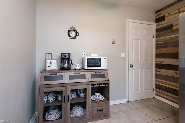 room details featuring white microwave and baseboards