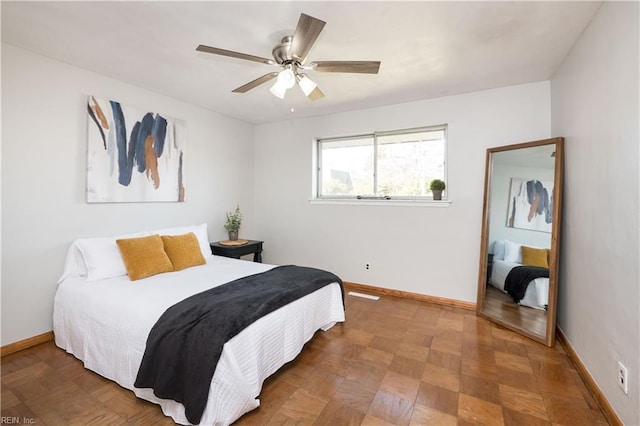 bedroom with ceiling fan and baseboards