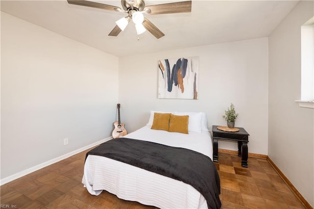 bedroom with ceiling fan and baseboards