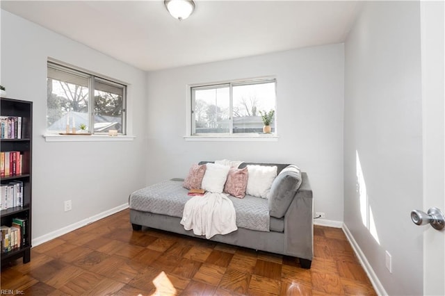 living area featuring a healthy amount of sunlight and baseboards