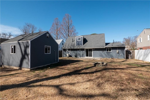 back of house with a lawn and fence