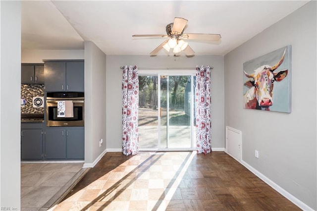 interior space with a ceiling fan and baseboards