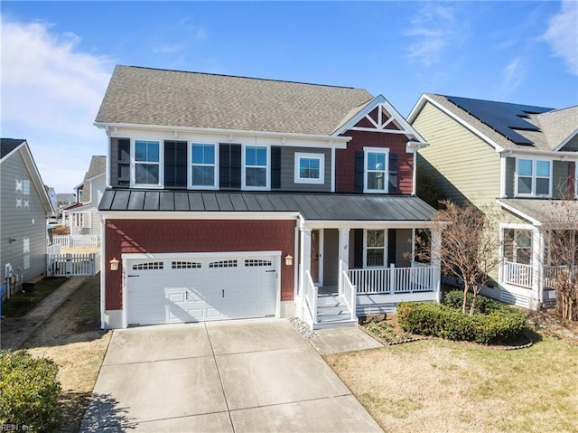 view of front of house featuring metal roof, an attached garage, covered porch, driveway, and a standing seam roof