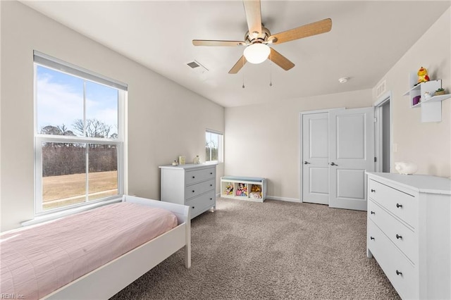 bedroom featuring ceiling fan, multiple windows, visible vents, and light colored carpet