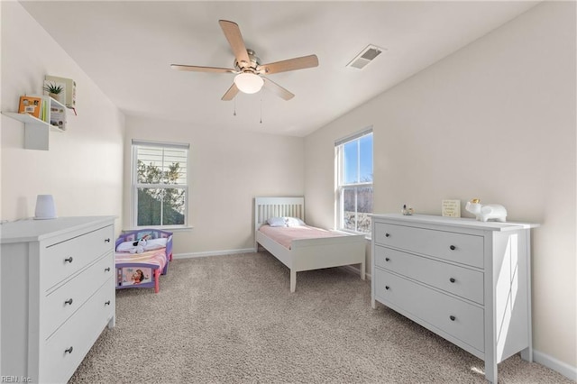 bedroom featuring light carpet, baseboards, visible vents, and a ceiling fan