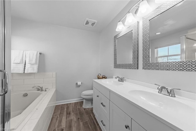 full bathroom with double vanity, a garden tub, wood tiled floor, and a sink