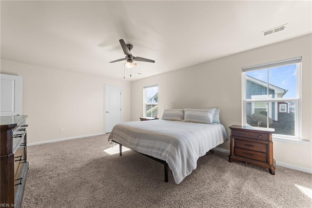 bedroom with carpet floors, visible vents, baseboards, and a ceiling fan