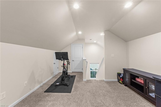 exercise room with recessed lighting, light colored carpet, vaulted ceiling, and baseboards