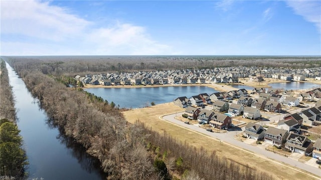 drone / aerial view featuring a residential view and a water view