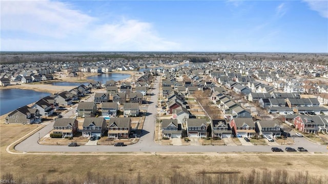 birds eye view of property featuring a water view and a residential view