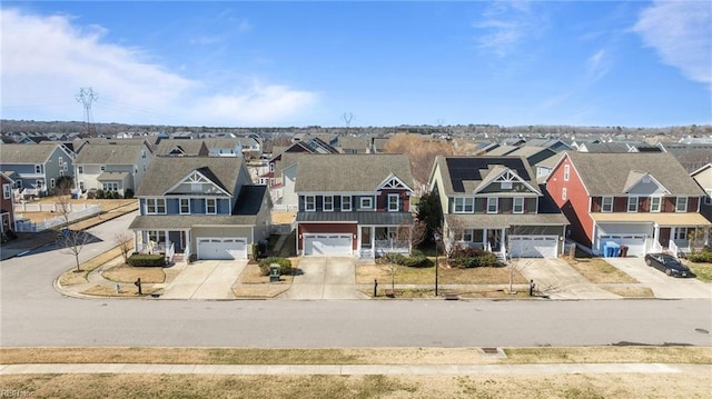 view of front of property featuring a residential view, driveway, and an attached garage