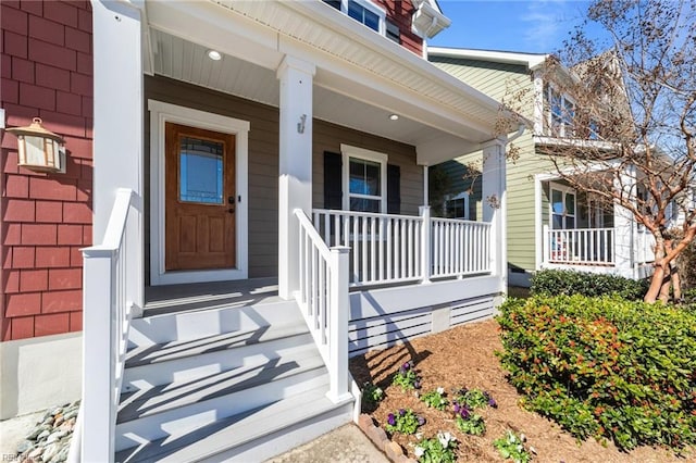 view of exterior entry with covered porch