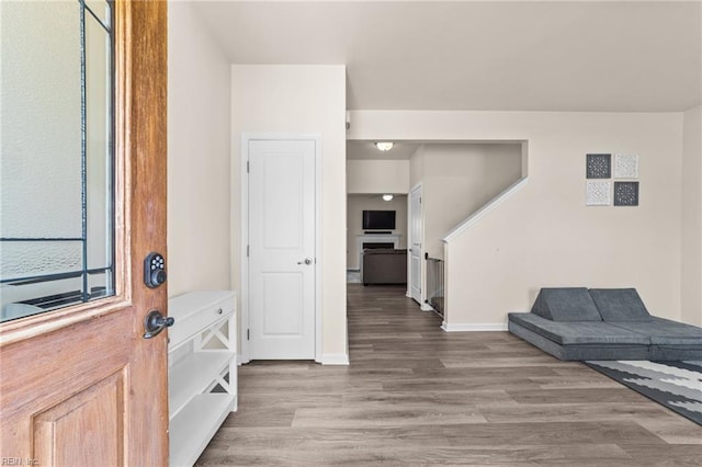 entryway with baseboards and wood finished floors