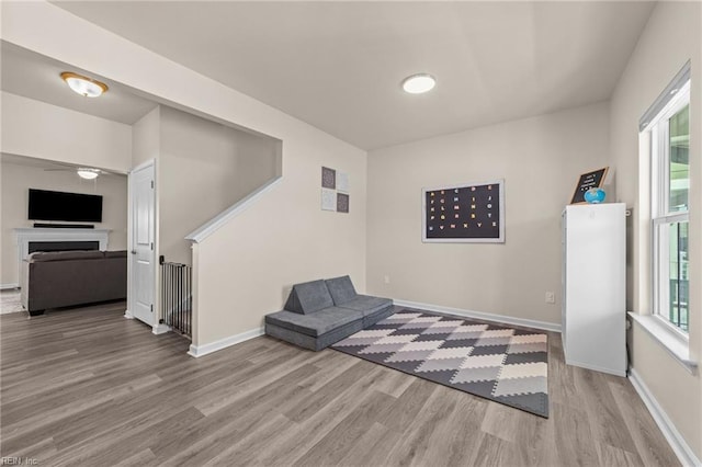 sitting room featuring light wood-style flooring and baseboards