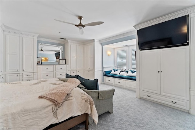 bedroom with crown molding, ceiling fan, visible vents, and light colored carpet