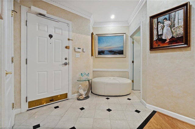 entryway with ornamental molding, tile patterned flooring, and baseboards