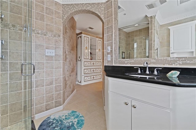 full bathroom featuring visible vents, vanity, a shower stall, and tile patterned floors