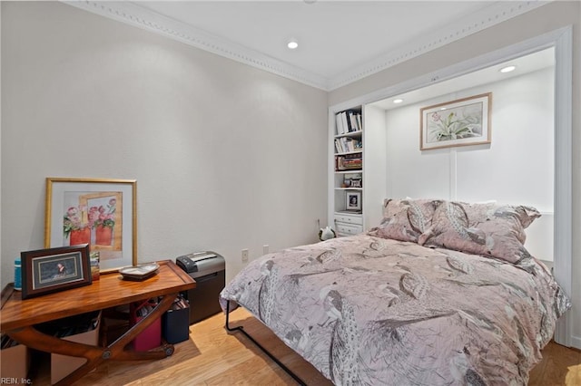 bedroom featuring ornamental molding, wood finished floors, and recessed lighting