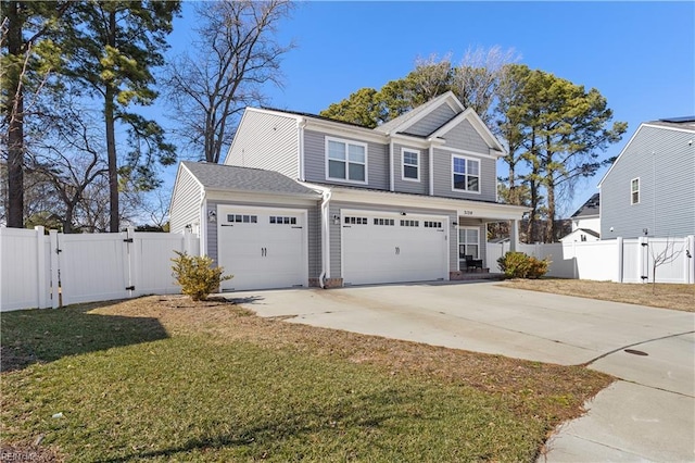 view of front of house featuring driveway, a gate, fence, and a front lawn