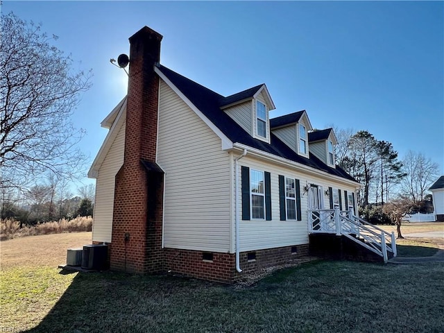 view of side of property with crawl space, a lawn, a chimney, and central air condition unit