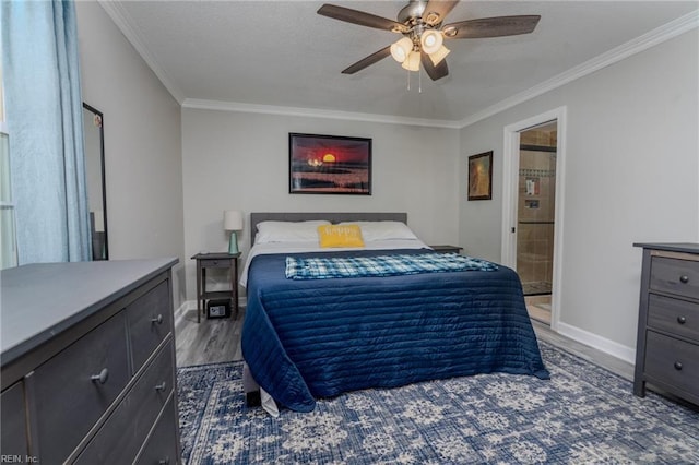 bedroom featuring baseboards, a ceiling fan, ensuite bath, wood finished floors, and crown molding