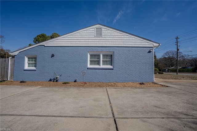 view of property exterior featuring brick siding