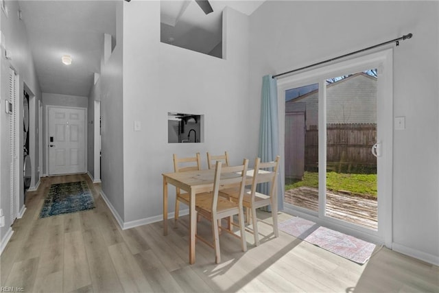 dining area with light wood-style flooring and baseboards