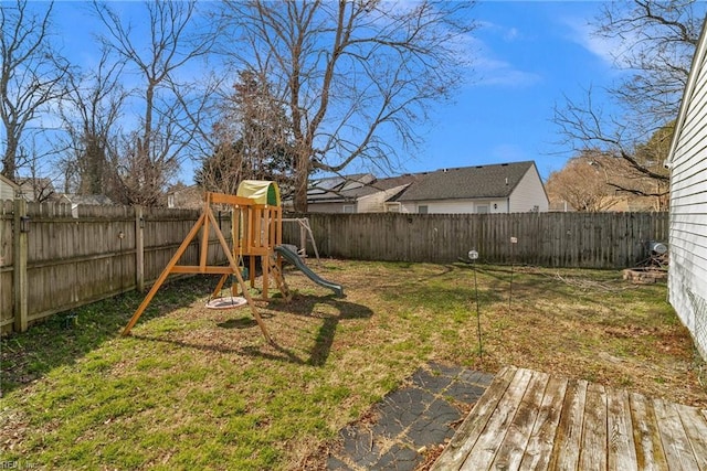 view of yard with a fenced backyard and a playground