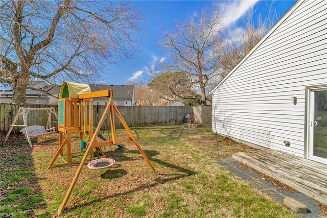 view of yard with a fenced backyard and a playground