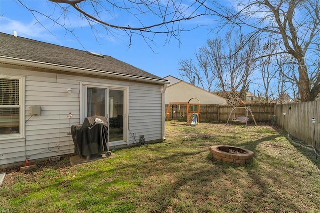 view of yard featuring a fire pit and a fenced backyard