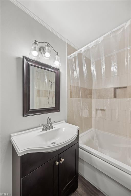 bathroom featuring ornamental molding, shower / bath combo, vanity, and wood finished floors