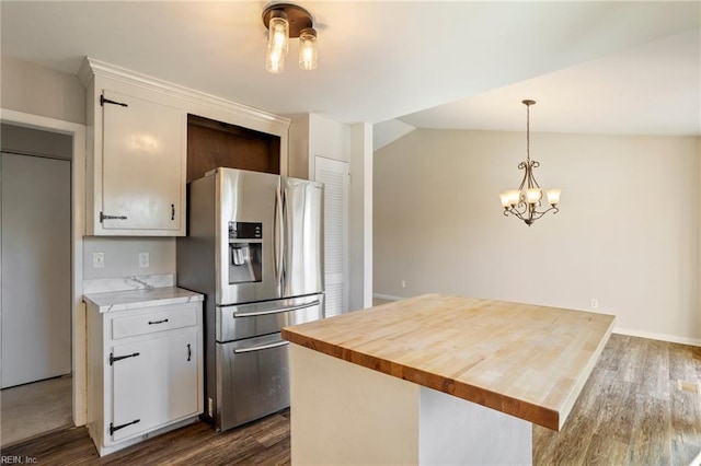 kitchen featuring a center island, decorative light fixtures, dark wood finished floors, white cabinetry, and stainless steel fridge