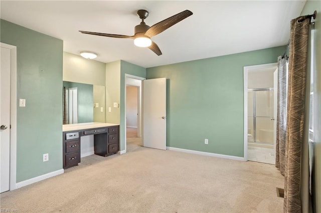 unfurnished bedroom featuring baseboards, ensuite bathroom, and light colored carpet