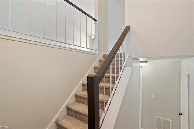 stairs with visible vents and baseboards