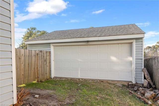 detached garage featuring fence