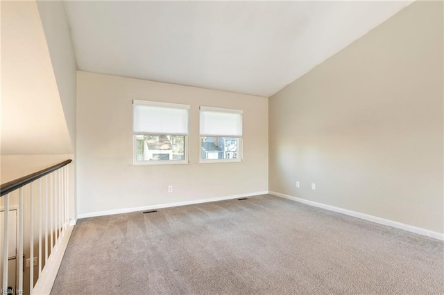 spare room featuring light carpet, visible vents, and baseboards