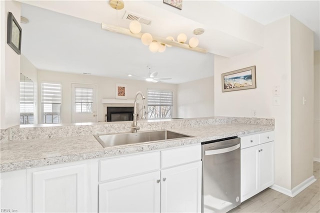 kitchen with a wealth of natural light, visible vents, a sink, and stainless steel dishwasher