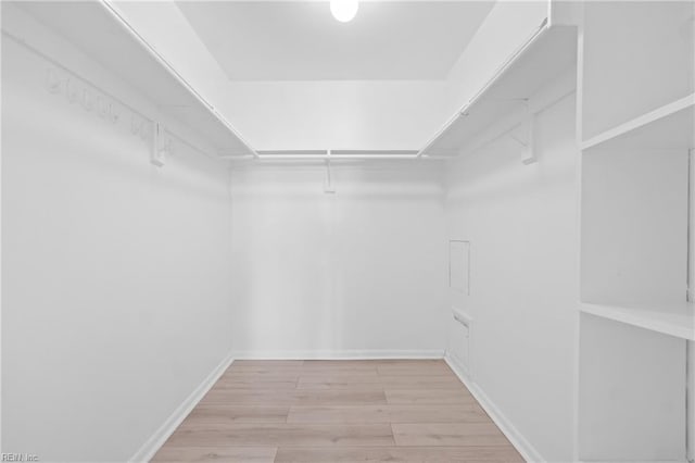 spacious closet with wood finished floors