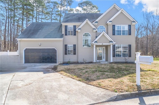 view of front of home featuring a garage, driveway, and a front lawn