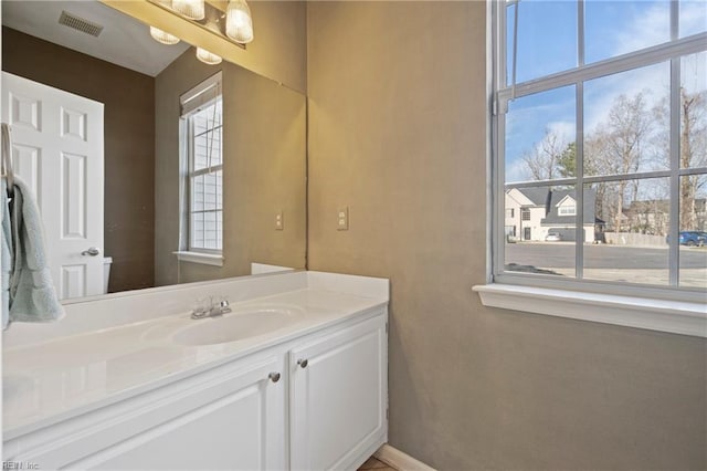 bathroom with visible vents, vanity, and baseboards