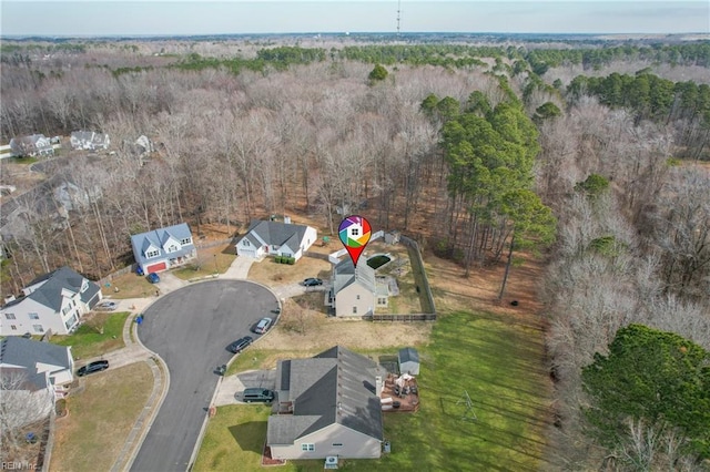 bird's eye view featuring a wooded view