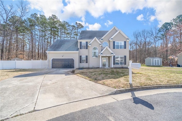 view of front of house featuring an attached garage, a storage shed, fence, concrete driveway, and a front yard