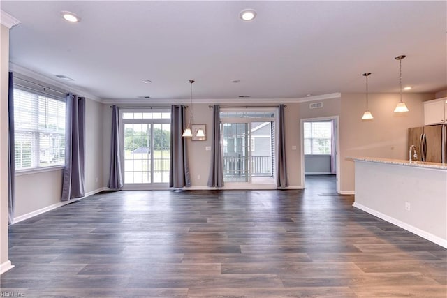 unfurnished living room with dark wood-style floors, crown molding, recessed lighting, visible vents, and baseboards