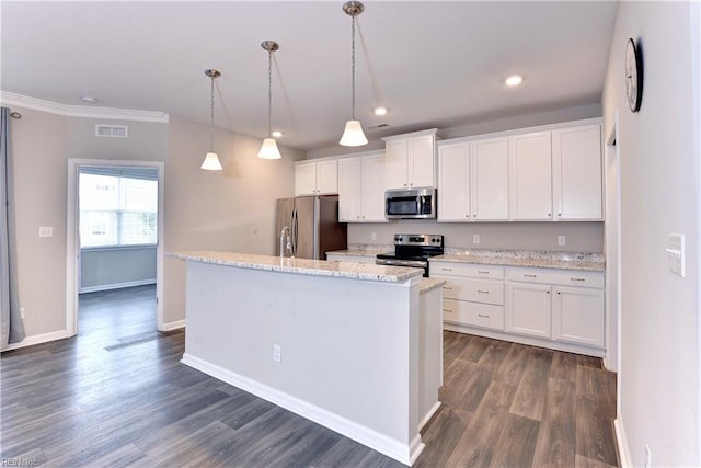 kitchen with light stone counters, stainless steel appliances, hanging light fixtures, a kitchen island with sink, and white cabinets