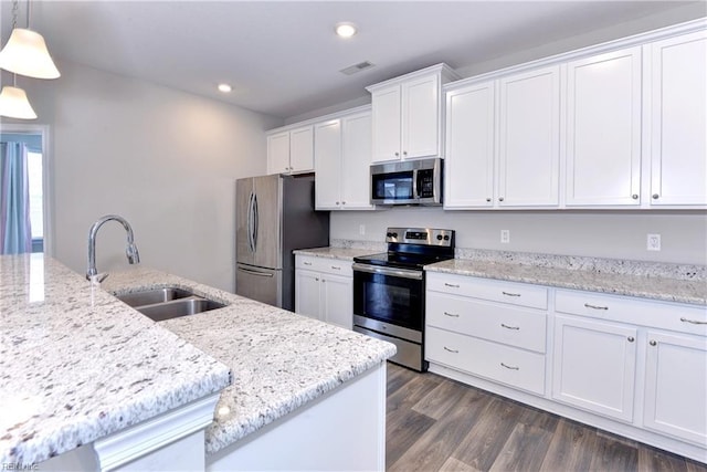 kitchen featuring a sink, visible vents, white cabinetry, hanging light fixtures, and appliances with stainless steel finishes