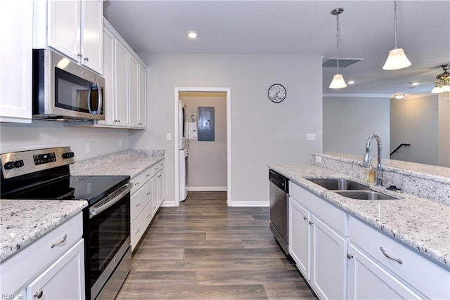 kitchen featuring stainless steel appliances, white cabinetry, a sink, and hanging light fixtures