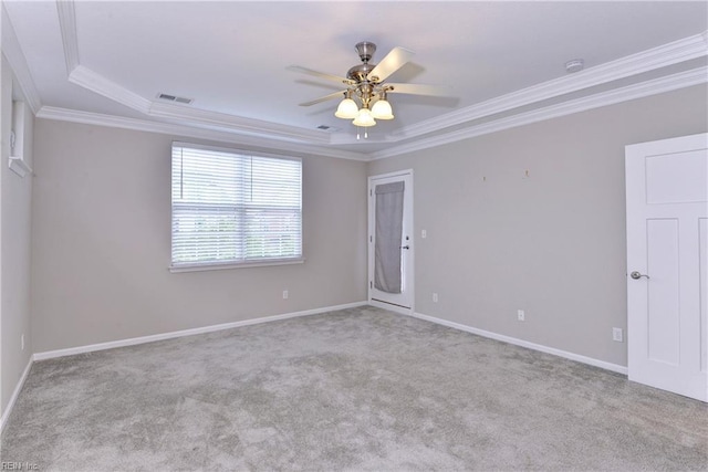 empty room featuring baseboards, visible vents, light colored carpet, ceiling fan, and ornamental molding