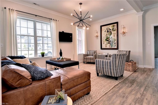 living room featuring a healthy amount of sunlight, visible vents, and ornamental molding