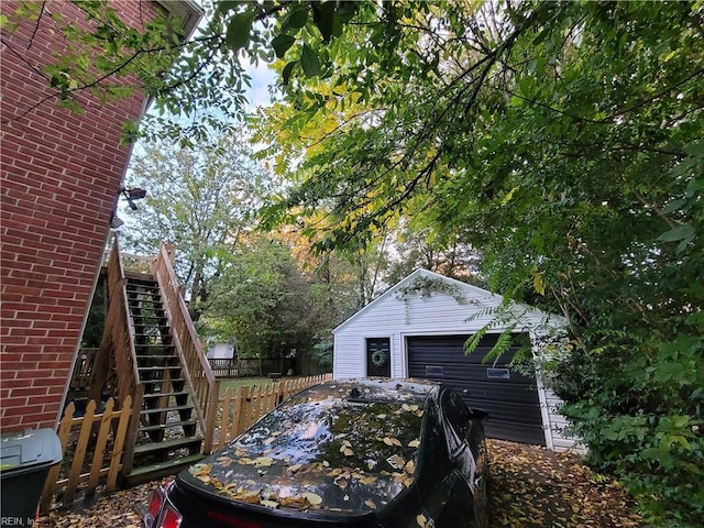 view of property exterior featuring an outbuilding and stairway